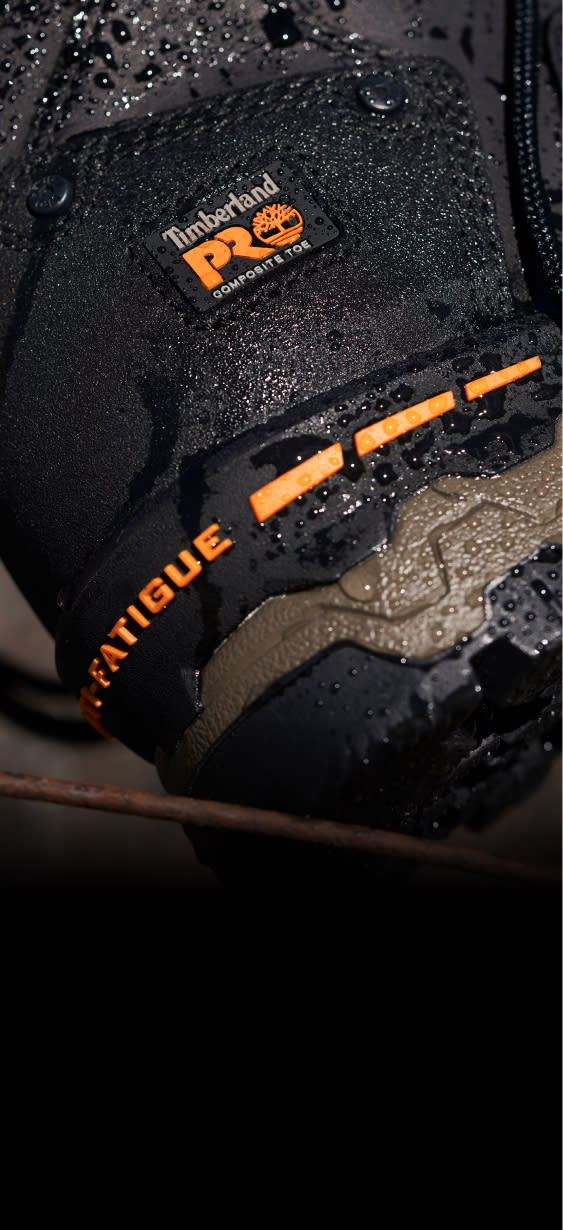 A close up image of the heel of a work boot with beads of water dripping off. 