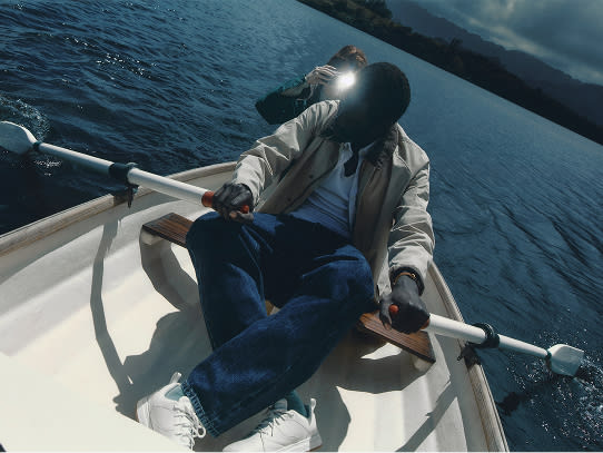 A close up image of a man rowing a boat .