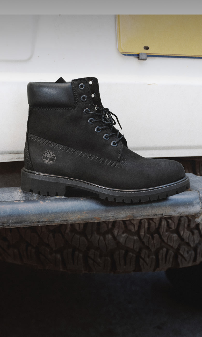 a black timberland boot on a tire