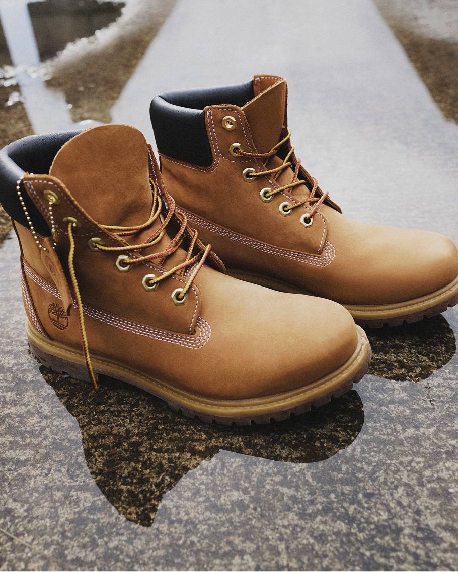 wet yellow suede timberland boots in a puddle outdoors