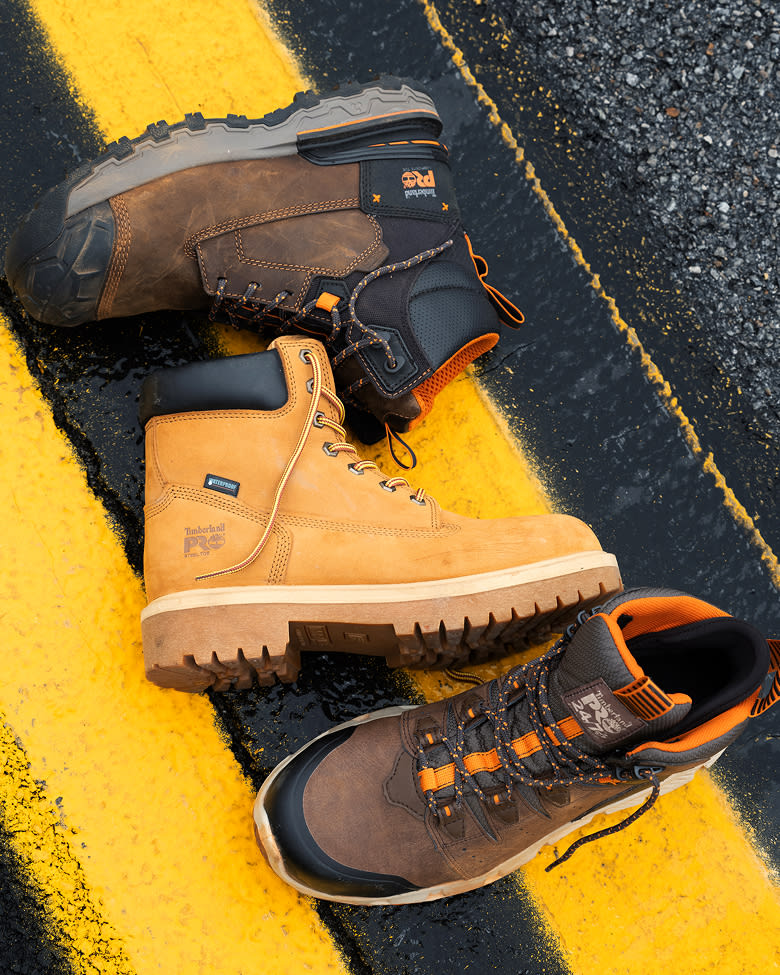 three individual timberland work boots lying on the side 