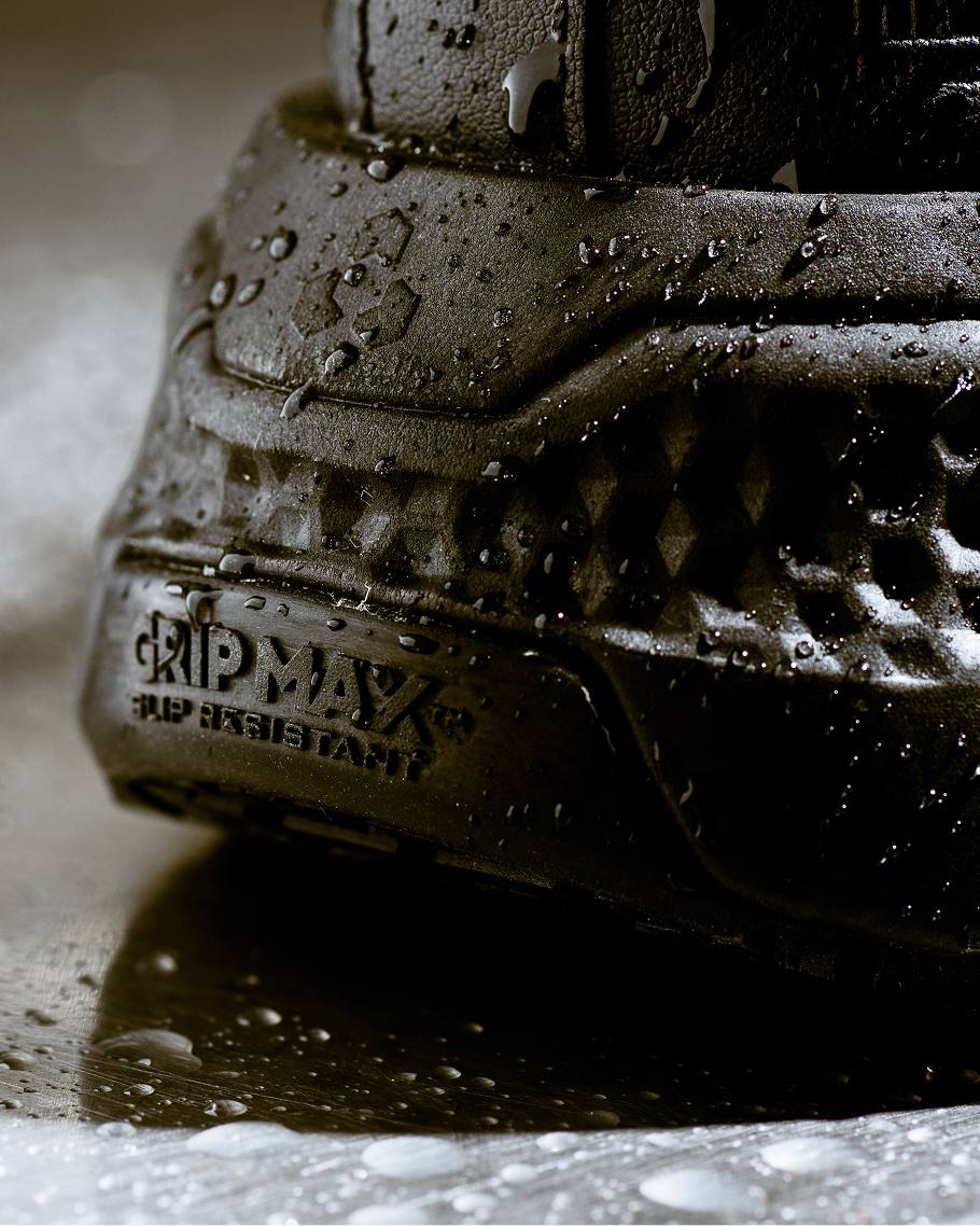a close up shot of black sneakers covered in water droplets