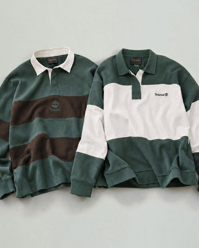 Two long-sleeved polo-style rugby shirts laid flat side-by-side against a pale grey background: the shirt on the left features wide dark green and brown horizontal stripes with a white collar, and the shirt on the right features a large white block panel across the chest and sleeves with a green collar, green base, and green upper shoulders.