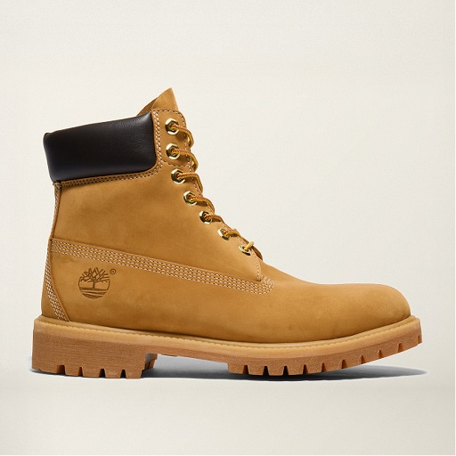 Classic wheat nubuck 6-inch Timberland boot with dark brown collar, brass eyelets, and tan rawhide laces.