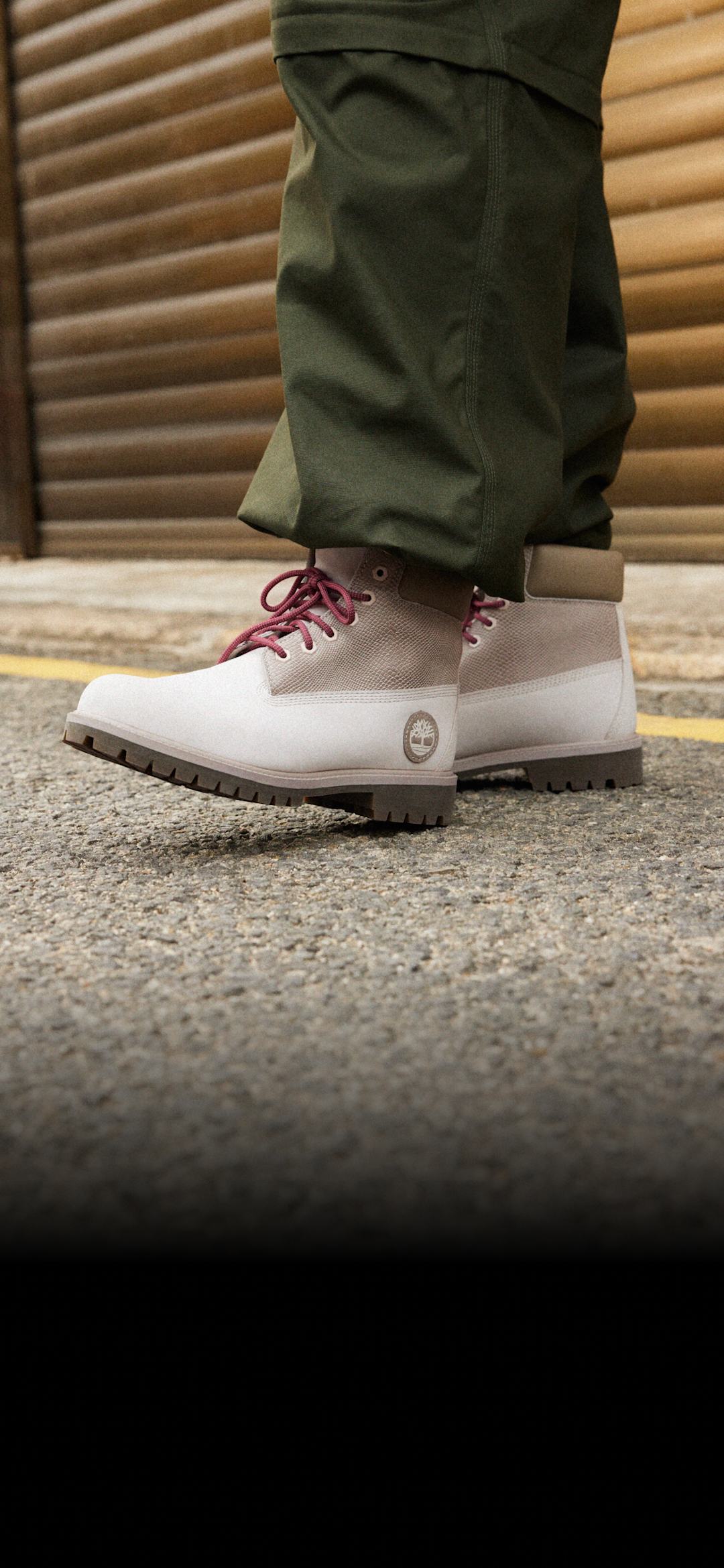 Two-toned grey boots with red laces.