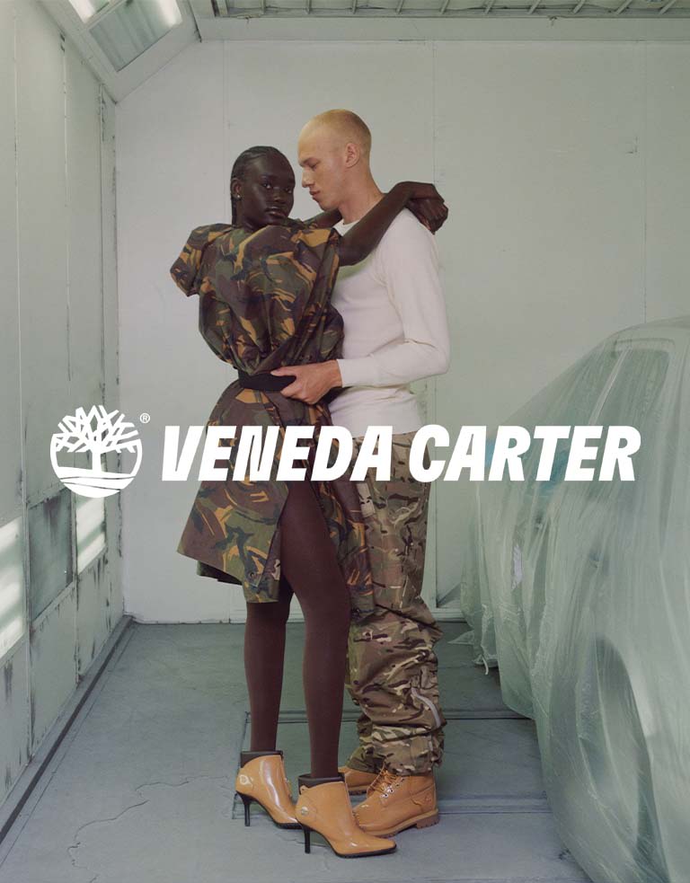 Image of a man and a woman wearing Veneda Carter x Timberland shoes in a garage.