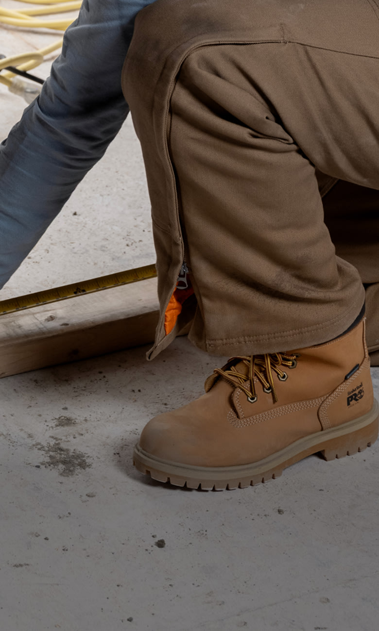 contractor leaning down in timberland work boots